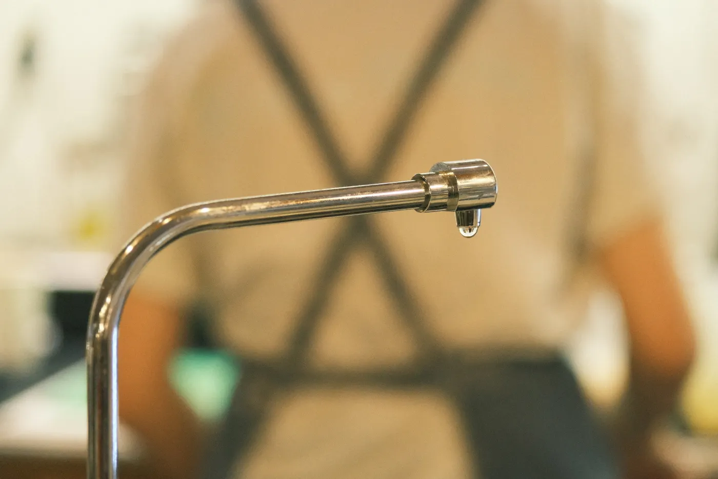 Close-up of a dripping indoor faucet